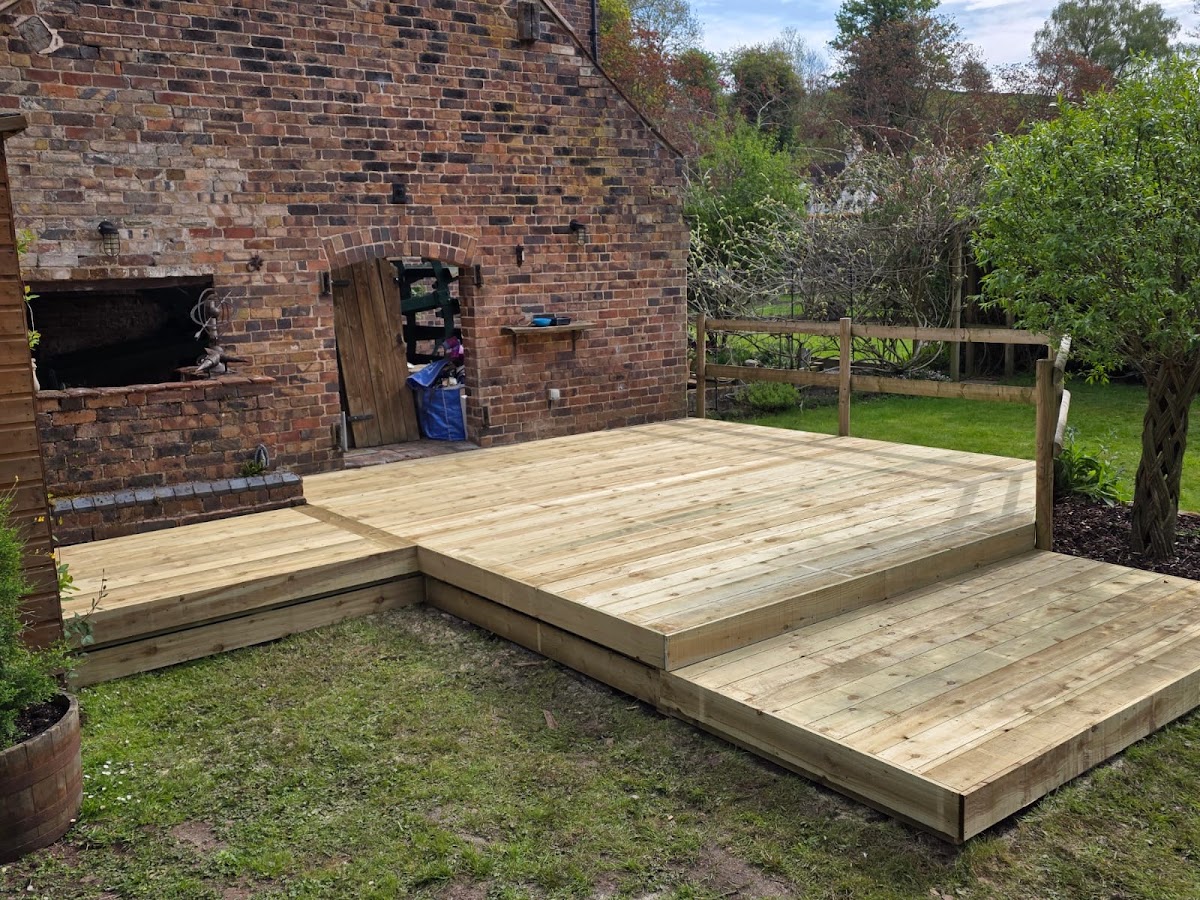 Split-level decking with steps against a period brick house