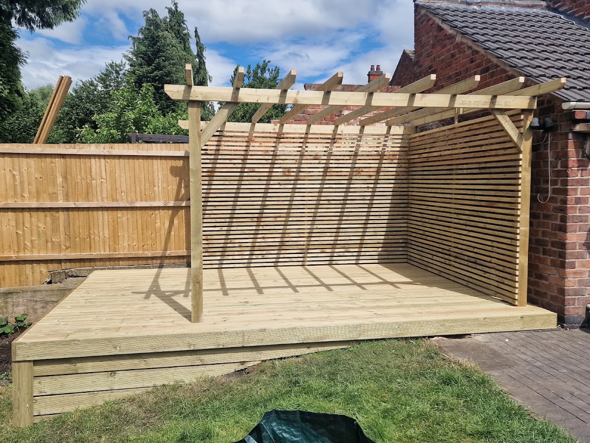 A timber pergola over decking with a contemporary slatted screen