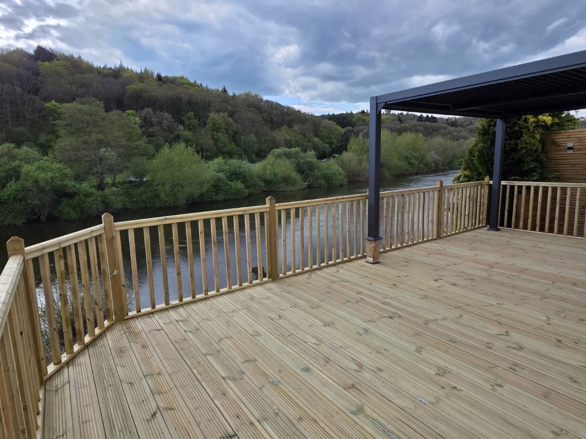 A raised riverside deck with balustrade built by Mike's Timber Solutions